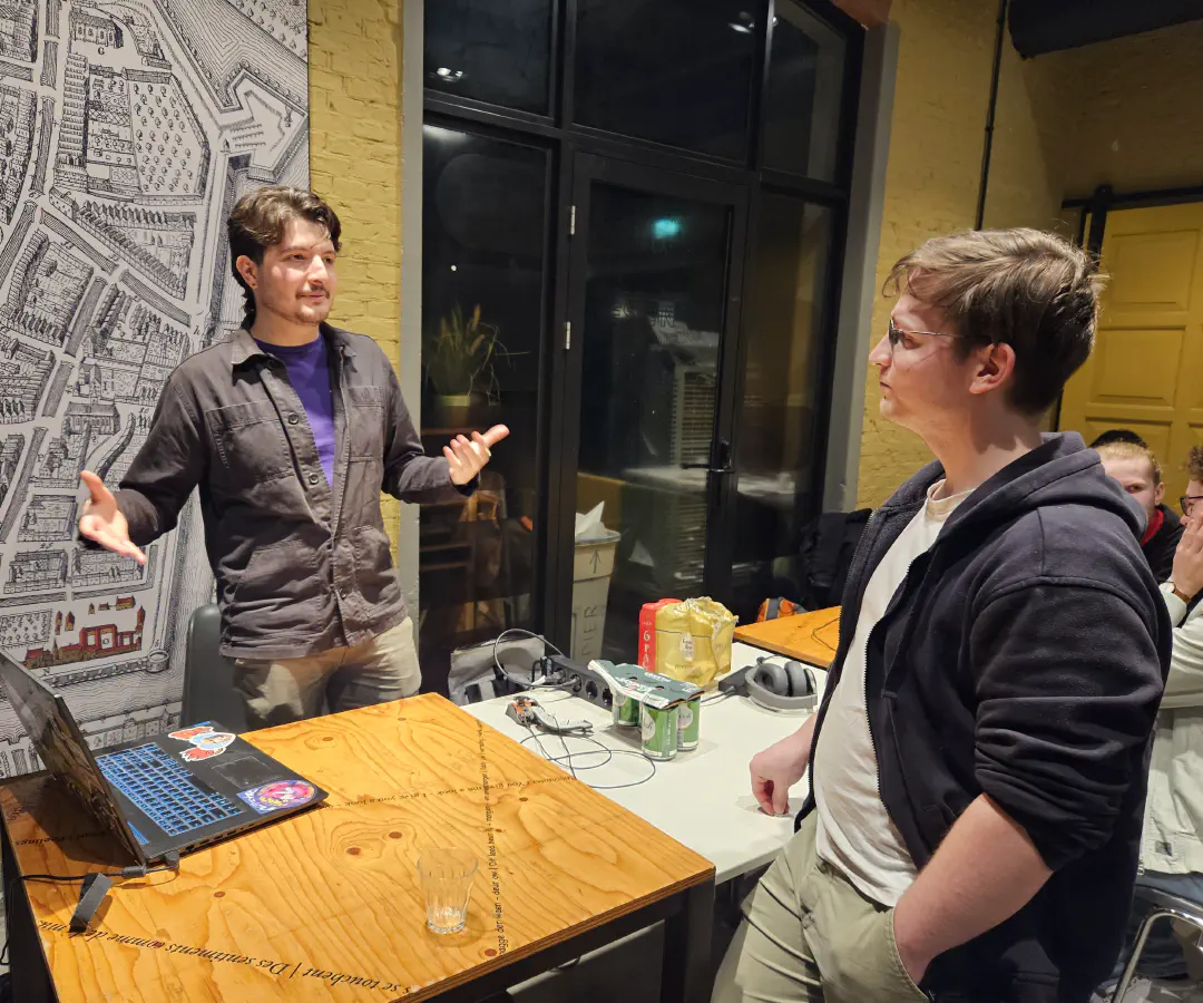 A photo taken during the Open Dev Mix, two people are talking