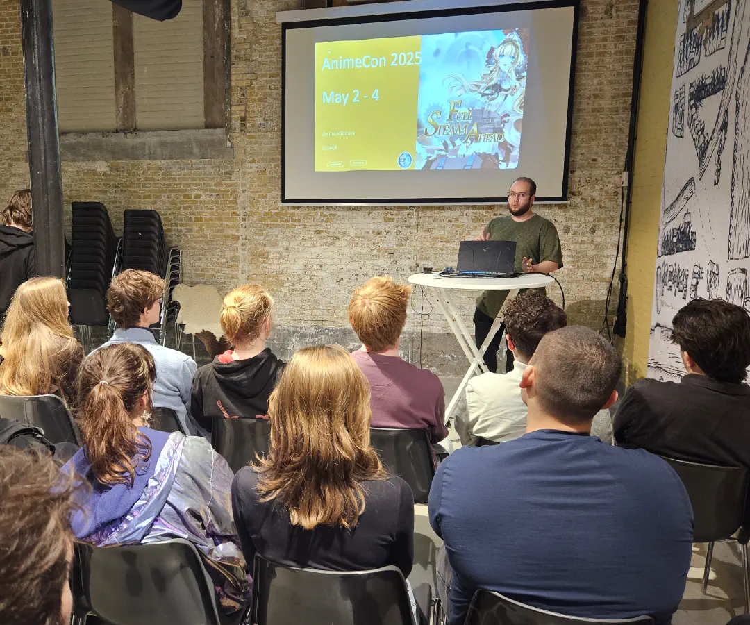 A photo taken during the Open Dev Mix, a person is giving a talk in front of an audience